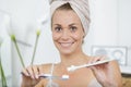 woman with towel on head going to brush teeth Royalty Free Stock Photo