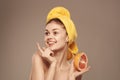 woman with a towel on her head clean skin grapefruit in hand cropped view Royalty Free Stock Photo