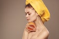 woman with a towel on her head clean skin grapefruit in hand cropped view Royalty Free Stock Photo