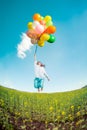 Woman with toy balloons in spring field Royalty Free Stock Photo