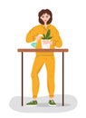 Woman in a tracksuit watering flowers