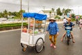 A woman trader with mobile food cart