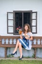 Woman in traditional bavarian dress holding beer and pretzel Royalty Free Stock Photo