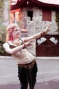 Woman in traditional belly dance costume standing with outstretched arms in front of buddhist temple Royalty Free Stock Photo