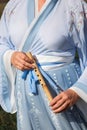 A woman in a traditional Chinese hanfu dress holds bamboo flute close-up Royalty Free Stock Photo