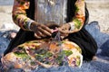 Woman in traditional dress mending fishing net, Oman Royalty Free Stock Photo