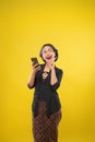 woman with traditional Javanese clothes excited looking up