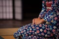 Woman in traditional kimono in kneeling position. Seiza is the formal way of sitting down based on ancient Japanese standards
