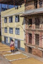 Woman in traditional nepalese dress drying rice in Kirtipur