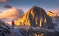 Woman on the trail looking on high mountain peak at sunset