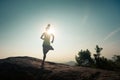 Woman trail runner running at mountain top