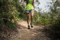Woman trail runner running on rocky trail
