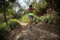 Woman trail runner running on tropical forest trail Royalty Free Stock Photo