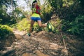 Woman trail runner running on tropical forest trail Royalty Free Stock Photo
