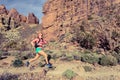 Woman trail running in mountains with backpack Royalty Free Stock Photo