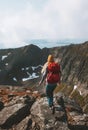 Woman trail running in mountains with red backpack travel lifestyle hiking solo Royalty Free Stock Photo