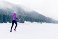 Woman running on winter trail, fitness inspiration and motivation Royalty Free Stock Photo