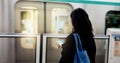 Woman, train travel and phone with back, bag and journey on metro railway with typing for web chat. Girl, person and Royalty Free Stock Photo