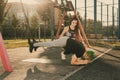 Woman trainer with braids hairstyle helping man man with mohawk hairstyle doing exercise outdoors using overhead training Royalty Free Stock Photo