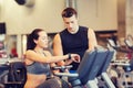 Woman with trainer on exercise bike in gym Royalty Free Stock Photo