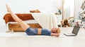 Woman training abdominal muscles lifting legs up lying on floor