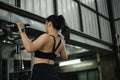 Woman training back on a pull-up machine in a gym, showing strength, focus, and an active lifestyle. Royalty Free Stock Photo