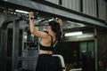 Woman training back on a pull-up machine in a gym, showing strength, focus, and an active lifestyle. Royalty Free Stock Photo