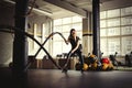 Woman training with battle ropes in gym Royalty Free Stock Photo