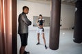 Woman training boxing with personal trainer. Instructor teaching female boxer fighting practice together Royalty Free Stock Photo