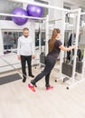 Woman training at gym using cable machine Royalty Free Stock Photo