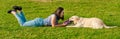 Woman training her dog golden retriever in the park Royalty Free Stock Photo