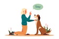 Woman training her pet dog. Happy puppy having command lesson. Royalty Free Stock Photo