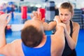 Woman is training with man on the self-defense course in gym. Royalty Free Stock Photo