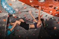 Woman training on practice climbing wall indoor Royalty Free Stock Photo