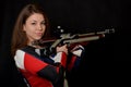 Woman training sport shooting with air rifle gun