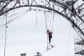 Woman training on trapeze for an outdoor aerobatics show in the main place of Mulhouse