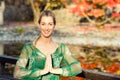 Woman training yoga outdoor in autumn park Royalty Free Stock Photo