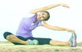 Woman training yoga poses sitting on beach Royalty Free Stock Photo