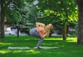 Woman training yoga in twisting awkward pose