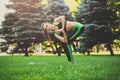 Woman training yoga in twisting awkward pose