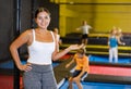 Woman trampolining coach against the background of children playing and jumping on a trampoline Royalty Free Stock Photo