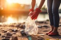 Woman with trash bag picking up plastic bottle at lake beach. Generate Ai