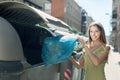 Woman with trash bags near garbage bin Royalty Free Stock Photo
