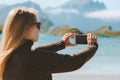 Woman travel blogger taking photo by smartphone influencer lifestyle
