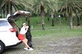 Woman travel by car to golf, woman loading a golf bag