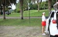 Woman travel by car to golf, woman loading a golf bag Royalty Free Stock Photo