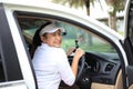 Woman travel by car to golf, woman loading a golf bag Royalty Free Stock Photo