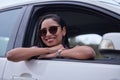 Woman, travel and car in window with smile for road trip, journey and adventure on vacation for wellness. Female person Royalty Free Stock Photo