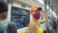 Woman travel caucasian ride at overground train airtrain with wearing protective medical mask. Girl tourist at airtrain Royalty Free Stock Photo