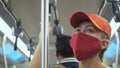 Woman travel caucasian ride at overground train airtrain with wearing protective medical mask. Girl tourist at airtrain Royalty Free Stock Photo